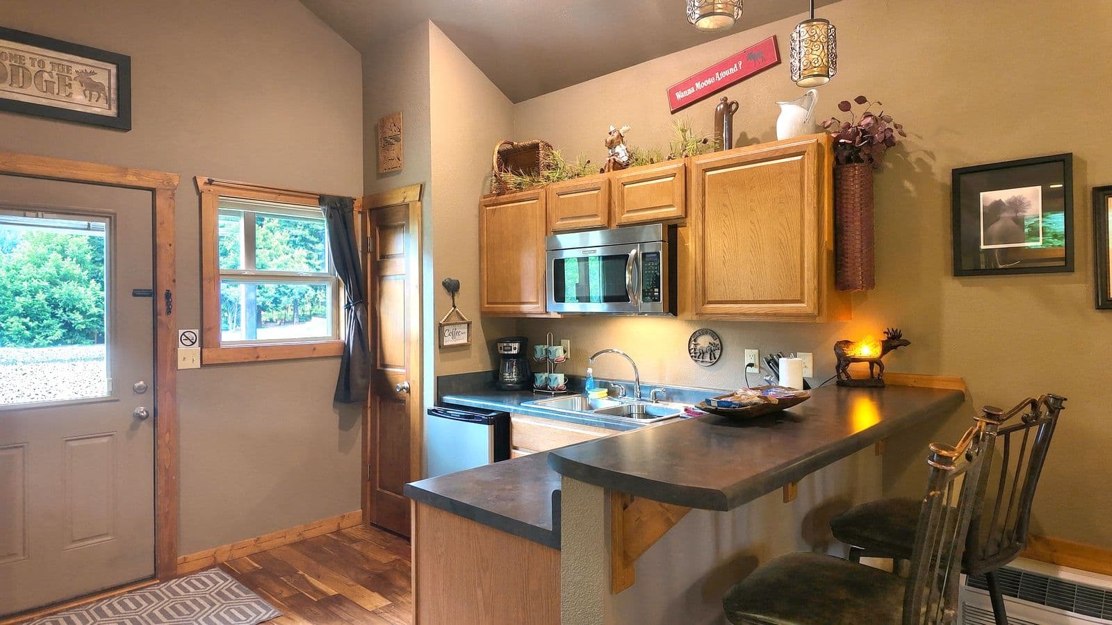 Cozy kitchen with wooden cabinets, modern appliances, and a bar counter.