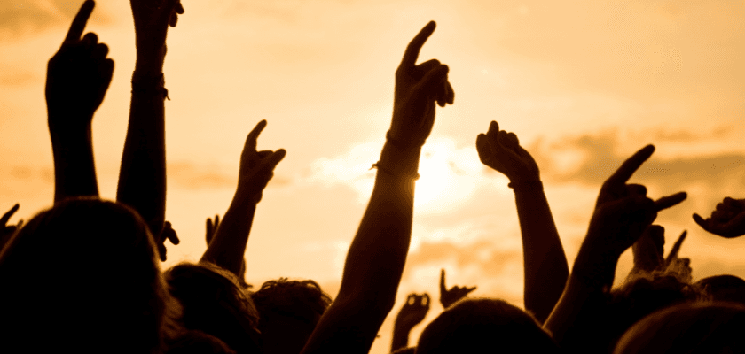 Silhouettes of hands raised against a sunset sky. Silhouettes of hands raised against a sunset sky.