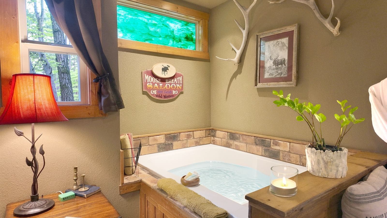 Cozy bathroom featuring a tub, wood accents, a lamp, and decorative elements.