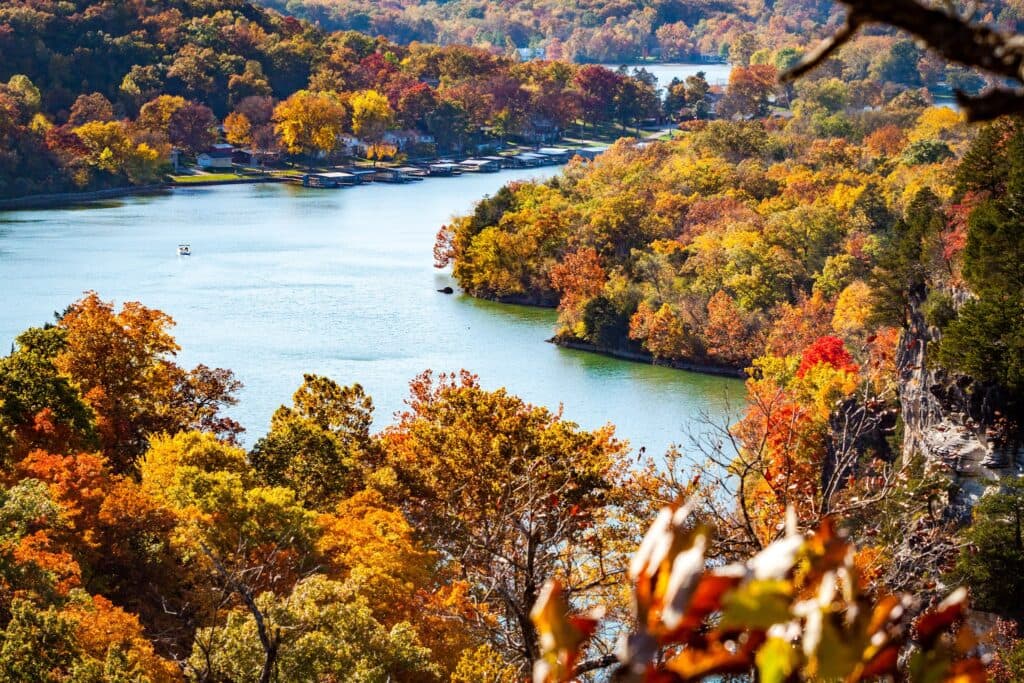 A scenic view of a river surrounded by vibrant autumn foliage.