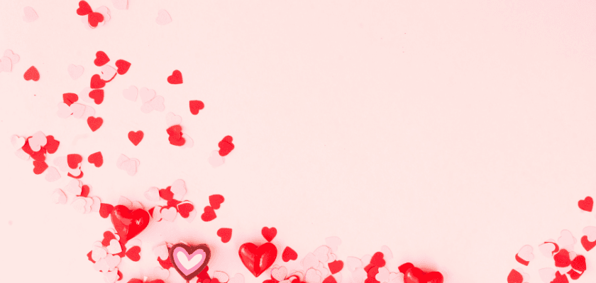 A pink background scattered with red and pink heart-shaped confetti. A pink background scattered with red and pink heart-shaped confetti.