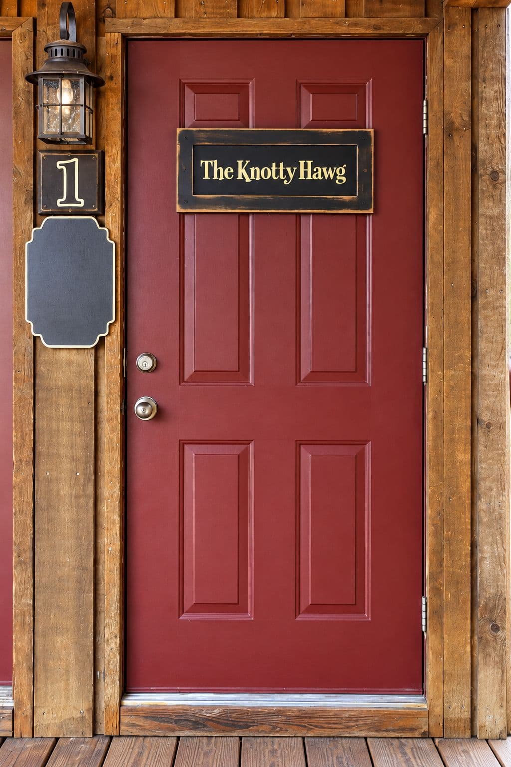 A red door with a wooden frame, featuring a sign that reads "The Knotty Hawg."
