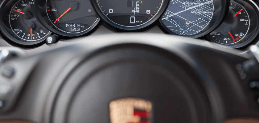 Close-up of a car's dashboard displaying speed, fuel, and a navigation map. Close-up of a car's dashboard displaying speed, fuel, and a navigation map.